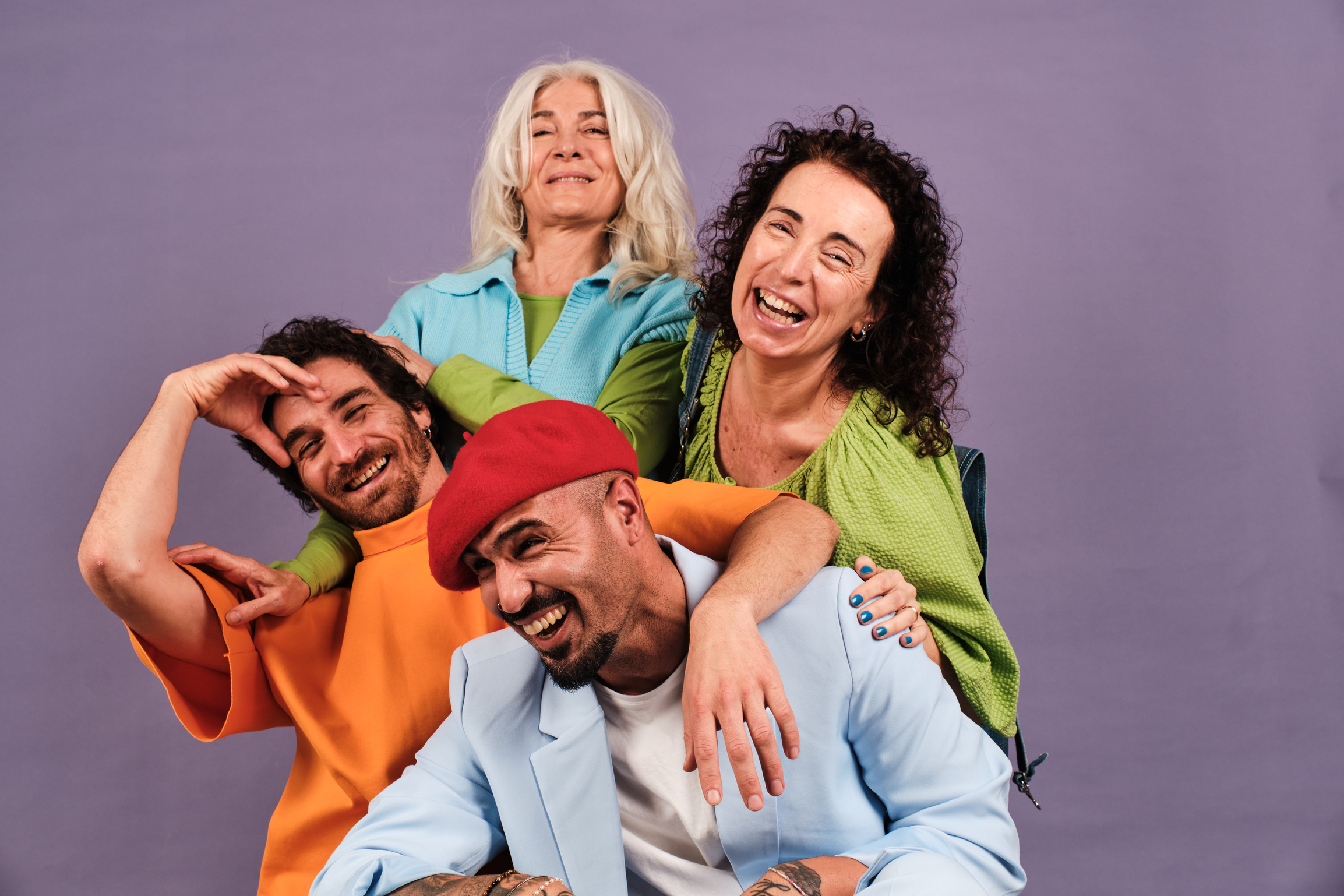 Playful Group Portrait of Creative Professionals on Purple Background