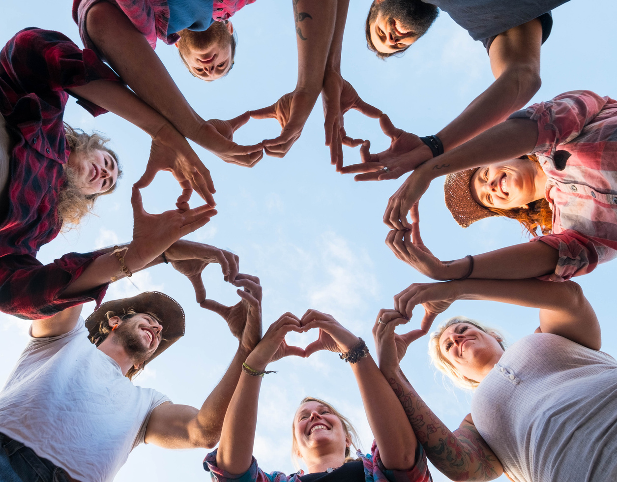 People Together Doing an Heart with Their Fingers